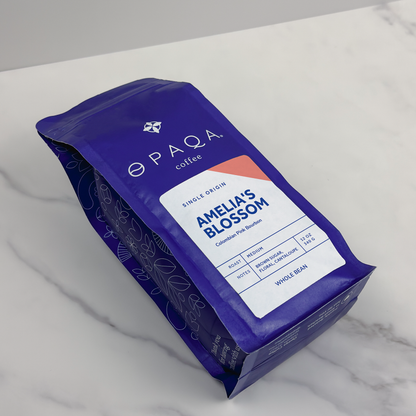 Opaqa Coffee's Amelia's Blossom bag on a marble surface, showcasing single-origin Colombian beans.