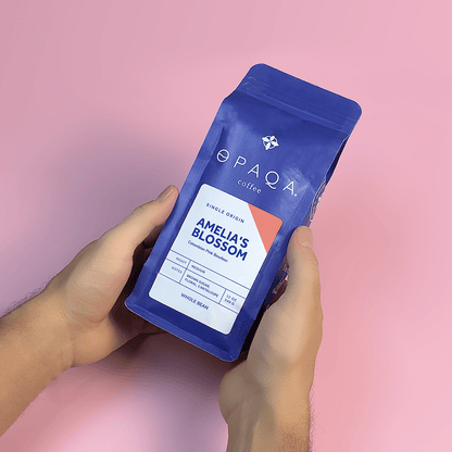 Amelia's Blossom coffee bag held in hands, highlighting its elegant design and premium beans