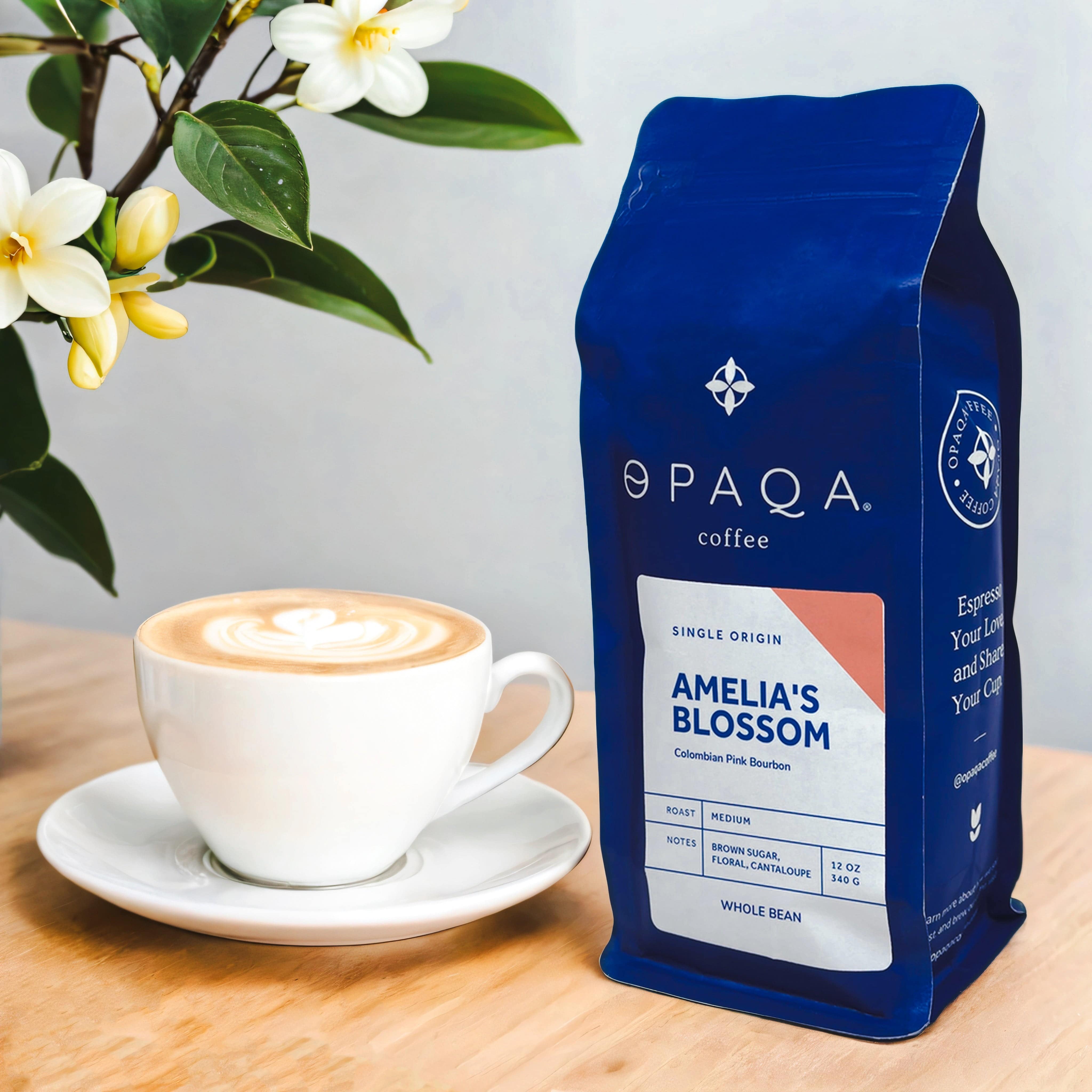 Amelia's Blossom coffee bag displayed with a latte, evoking floral and sweet flavor notes