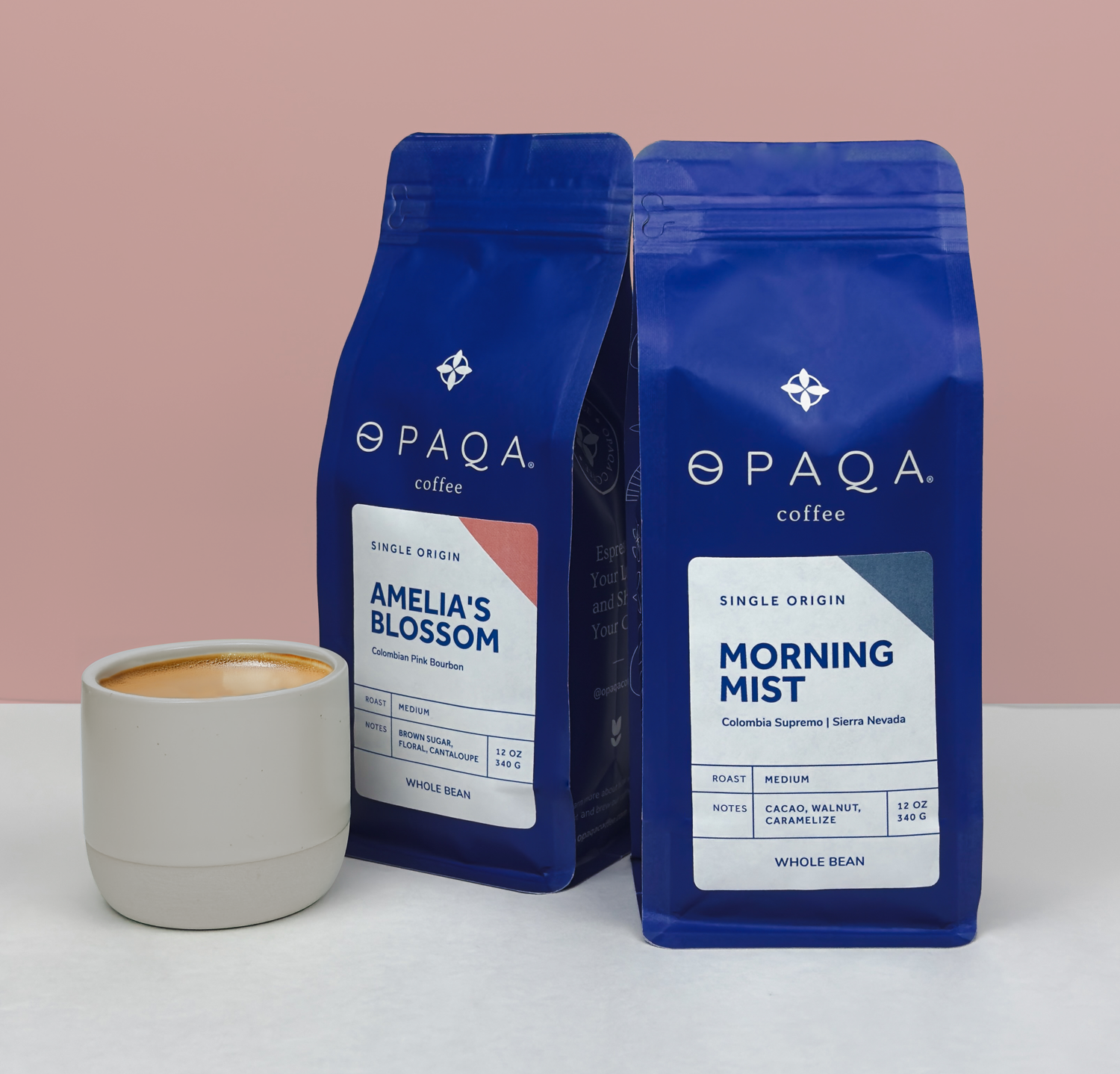 Two Opaqa coffee bags labeled 'Amelia's Blossom' and 'Morning Mist' with a cup of coffee on a light background.
