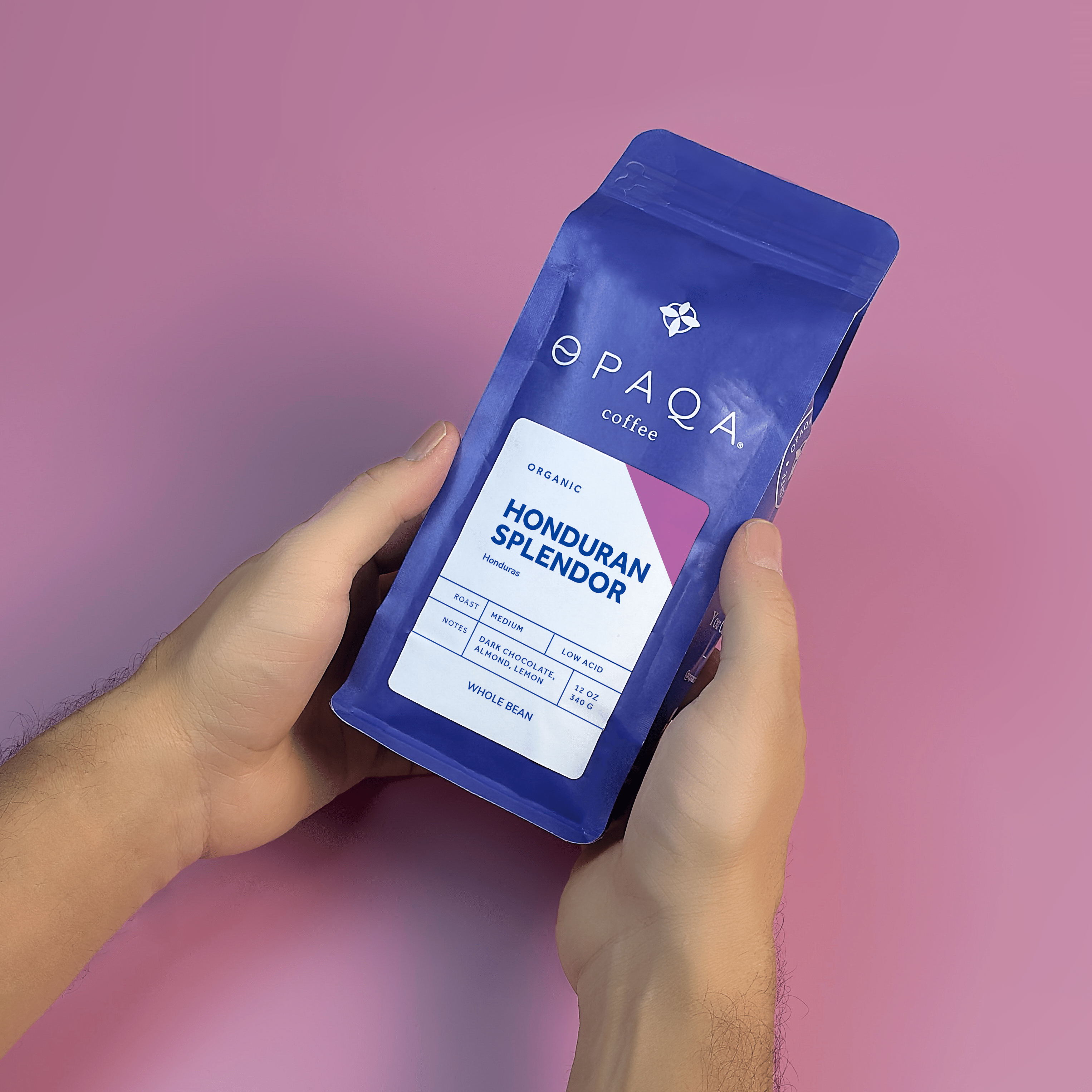 Hands presenting Honduran Splendor coffee bag. Organic specialty coffee with rich, smooth flavor notes